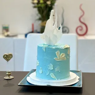 a blue cake with white frosting