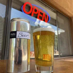 a glass of beer and a can of beer