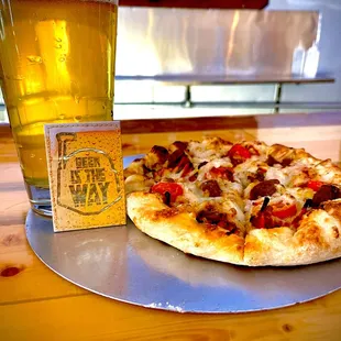 a pizza and a glass of beer