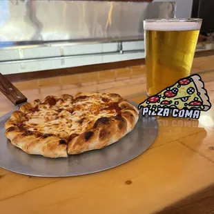 a pizza and a glass of beer