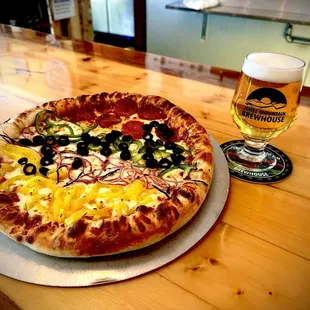 a pizza and a glass of beer