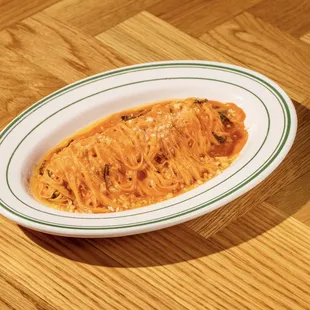 a plate of pasta on a wooden table
