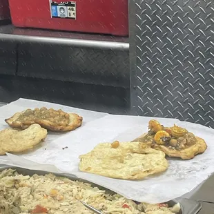 Regular Doubles (left), Shrimp Doubles (right), Saltfish (front)