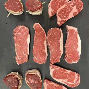 raw steaks on a cutting board