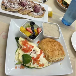 Egg white omelet with turkey, Swiss cheese and spinach  with fresh fruit and a homemade biscuit and blueberry pancake