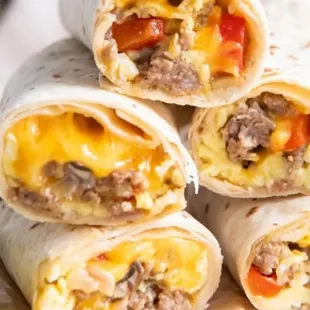 Breakfast wrap with eggs, cheese, meat, onions and potatoes