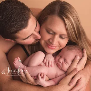 Newborn posed with parents