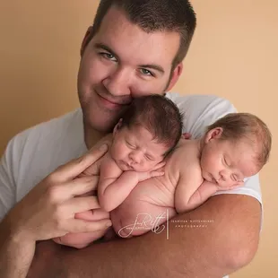 Daddy posed with his newborn twin boys