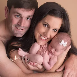 Newborn posed with parents