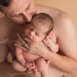 New daddy snuggling his baby girl