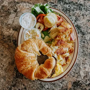a plate of food with a croissant