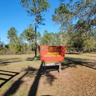 Another portion of the area and the grassy area is a parking lot