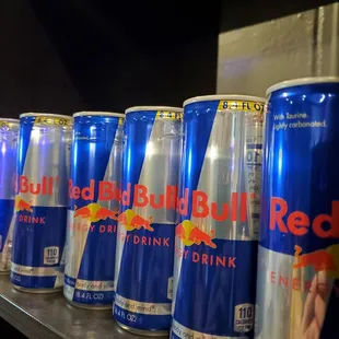 a row of red bull drink cans