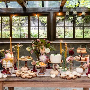 a table with desserts and candles