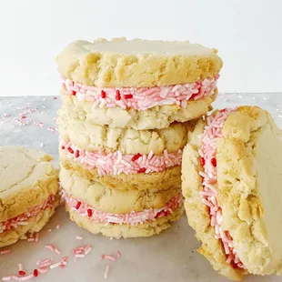 a stack of cookies with pink and white sprinkles