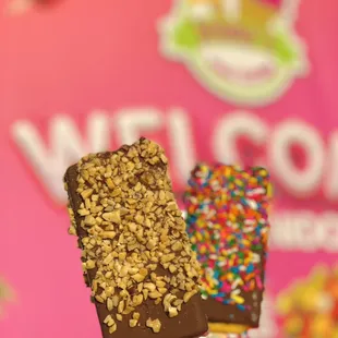 Ice cream popsicles covered in chocolate with sprinkles or peanuts