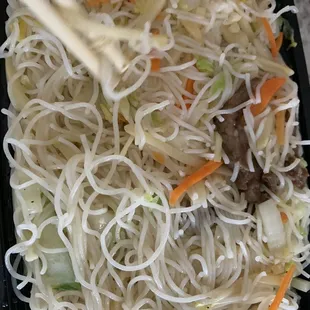 a plate of noodles with meat and vegetables