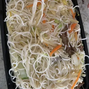 a plate of noodles and chopsticks