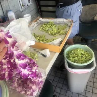Purple orchid leis and green orchid leis, made fresh!
