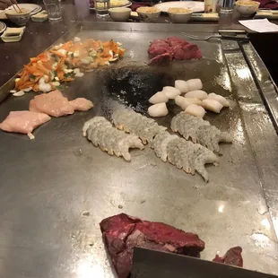 a grill with meat and vegetables