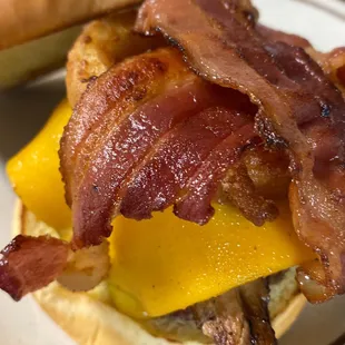 The Eastwood; 1/3 lb pattied burger with BBQ pulled pork, bacon, cheddar cheese and an onion ring on a brioche bun. The west is wild again!