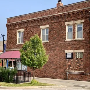 a brick building with a red awning
