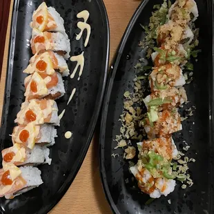 two black plates of sushi
