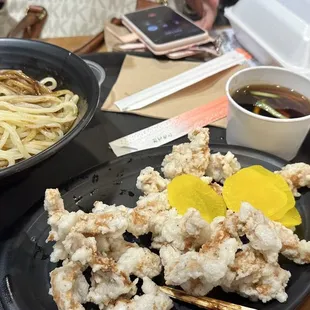 a plate of noodles and a bowl of soup