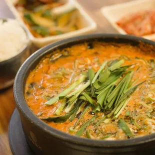 a bowl of soup and bowls of rice