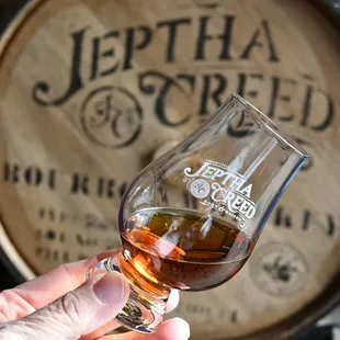 a hand holding a glass of wine