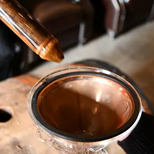 a person stirring a cup of hot chocolate