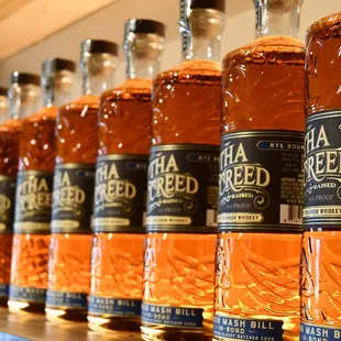 a row of bottles of whiskey