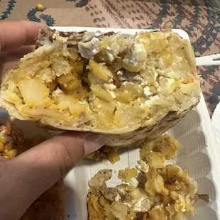 Cross section of the dry potato &quot;Cali&quot; burrito. It&apos;s literally a French fry burrito with a dash of mix ins.