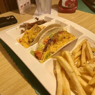 a plate of tacos and french fries