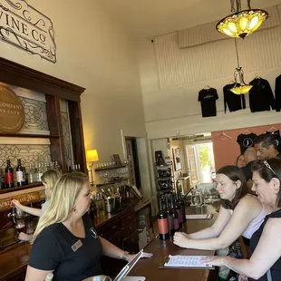 a group of women sitting at a bar