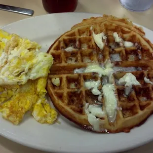 a waffle with eggs and bacon