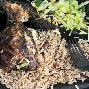 Jerk chicken, beans and rice and cabbage.