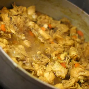 chicken and carrots cooking in a pot