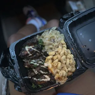 a person holding a tray of food