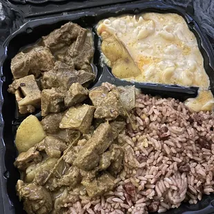 Curry goat rice and peas and Mac and cheese