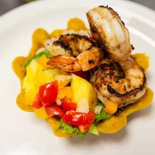 a plate of food with shrimp and peppers