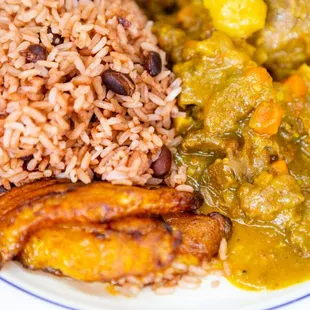 a plate of food with rice, beans, and meat