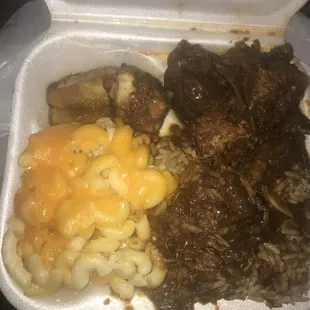 meat, macaroni and cheese in a styrofoam container