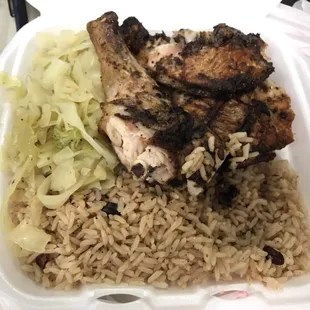 Jerk chicken plate with peas and rice as the side. Side order of cabbage medley