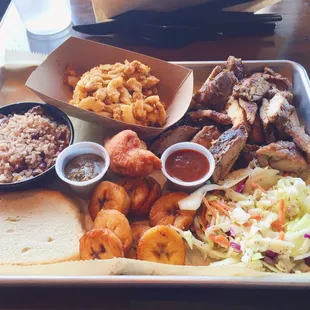 Jerk chicken plate with sides of Mac &amp; cheese, coconut rice &amp; beans, sweet plantains and island slaw.