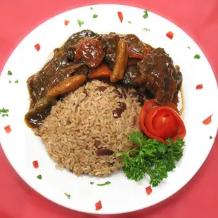 a white plate with rice and vegetables