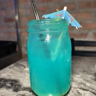 a blue drink in a mason jar