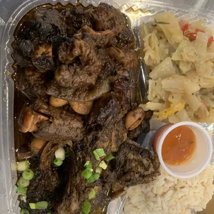 Stewed Oxtails and Brown Stewed Chicken combination with seasoned cabbage,plain rice and that famous homemade scotch bonnet pepper sauce!