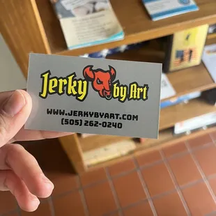 a hand holding a business card