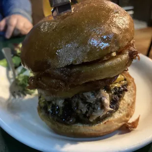 a burger with a knife stuck in it